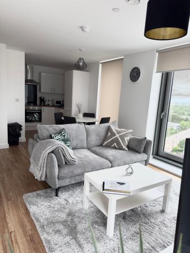 a living room with a couch and a table at Your private oasis in Manchester in Manchester