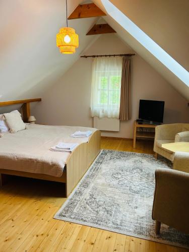 Una cama o camas en una habitación de In heart of Trakai you'll find authentic Karaim house