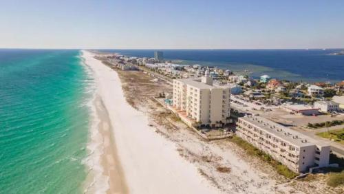 an aerial view of a beach with buildings and the ocean at Pensacola Beach Front Emerald Waters in Pensacola Beach