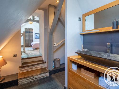 a staircase leading into a bathroom with a sink and a mirror at Gîte charmant avec jardin, proche activités nautiques - FR-1-622-75 in Morannes