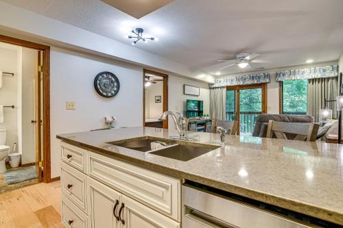 a kitchen with a sink and a living room at Hike and Leaf Peep! Condo 2 Mi to Silver Dollar City in Branson West