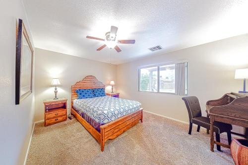 a bedroom with a bed and a ceiling fan at Local Living in Apache Junction in Apache Junction