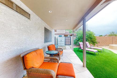 a patio with chairs and a table and grass at Local Living in Apache Junction in Apache Junction