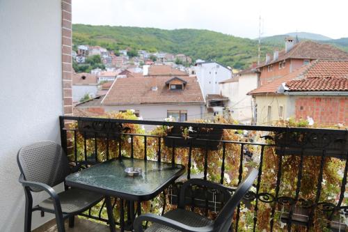 a table and chairs on a balcony with a view at Hotel Venisi in Prizren