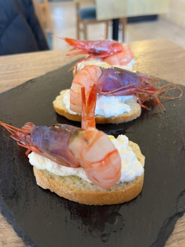 two lobsters sitting on top of bread with eggs at Al Pescatore Hotel & Restaurant in Gallipoli