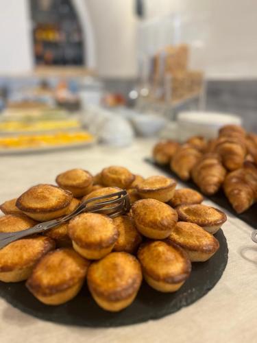 a bunch of donuts on a plate on a table at Al Pescatore Hotel & Restaurant in Gallipoli