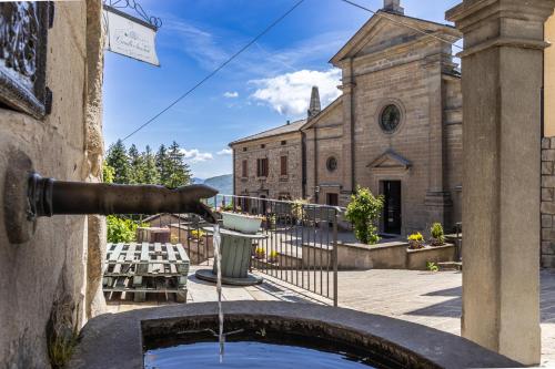 a water fountain in front of a church at Centro Storico Sestola Wifi e Netflix in Sestola