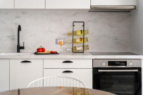 a kitchen with a table and a glass of wine at Sunday Luxury Suites in Agia Anna Naxos