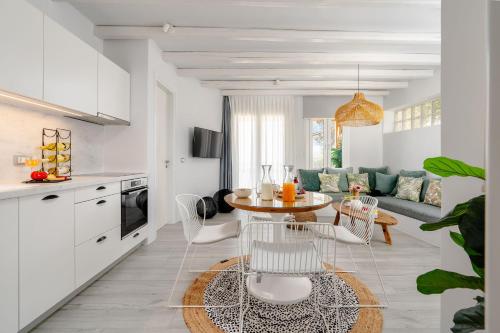 a kitchen and living room with a table and chairs at Sunday Luxury Suites in Agia Anna Naxos