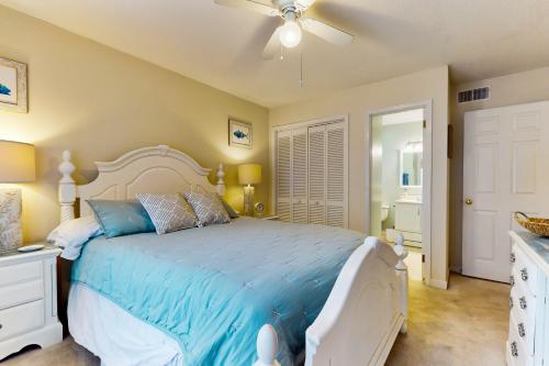 a bedroom with a bed and a ceiling fan at Spa on Port Royal Sound 1123 in Hilton Head Island