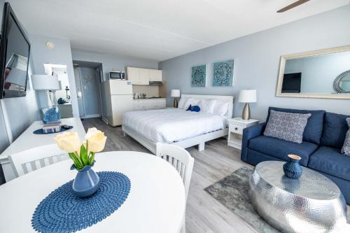 a bedroom and living room with a bed and a couch at Nassau Inn Beachfront in Wildwood Crest