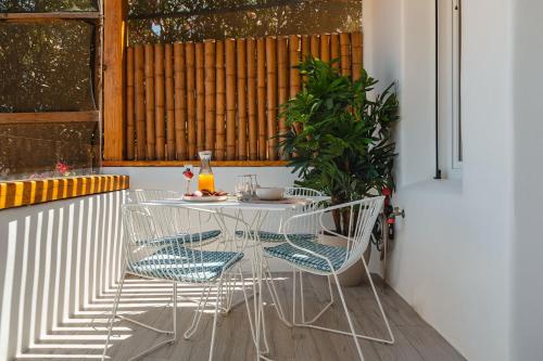 a white table and chairs on a balcony at Sunday Luxury Suites in Agia Anna Naxos