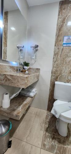 a bathroom with a sink and a toilet at Antonio's Hotel e Spa - Airport in Brasilia