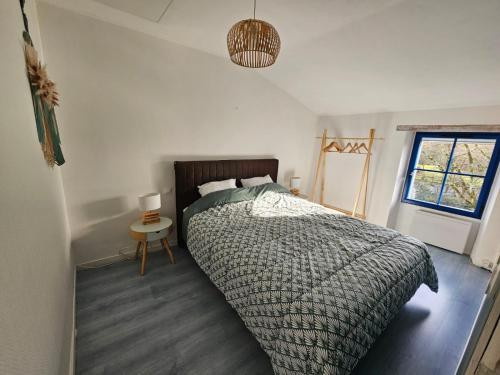 a bedroom with a large bed and a window at Gîte de charme avec spa privatif pour 4 à 6 personnes in Péault