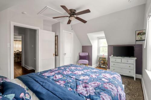 a bedroom with a bed and a ceiling fan at Private House + Yard Central Location to all RVA in Richmond
