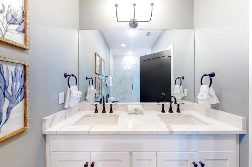 a bathroom with two sinks and a large mirror at Sandy Feet Retreat in Highland View