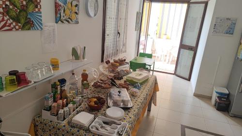 a kitchen with a table with food on it at B&B AMURI RANNI in Avola
