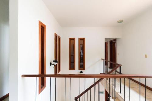 a row of windows in a white room with stairs at Wafeh Pampulha Suítes in Belo Horizonte