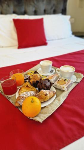 a tray of breakfast foods on a bed at U Baruni B&B in Messina