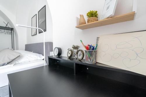 a black desk in a bedroom with a bed at Tranquil Wachau Escape - 45m2 with Outdoor Terrace in Mautern