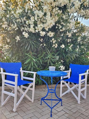 two chairs and a table with a blue table and chairs at 1939 in Kinion