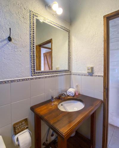 a bathroom with a wooden sink and a mirror at Las Margaritas in Potrerillos