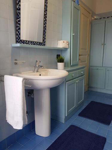 a bathroom with a sink and a mirror at Casa Lucia in Verzuolo