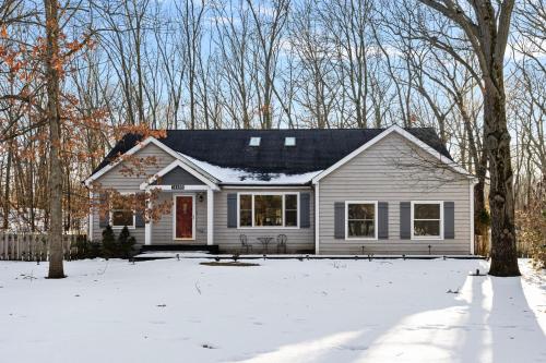 a white house in the snow with trees at The High Life in New Buffalo