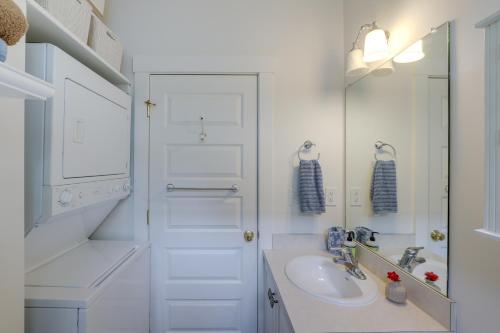 a white bathroom with a sink and a mirror at Summer Village Family Cottage with Community Perks! in Westford