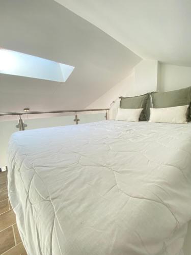 a large white bed in a white room at Coastal Dream in Finale
