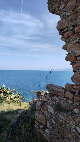 an old stone wall with the ocean in the background at Coastal Dream in Finale