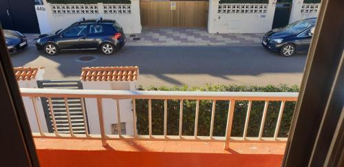 a balcony with a view of a parking lot with cars at Vacansis Habitaciones Privada en una Villa a un paso del Mar en Cullera in Cullera