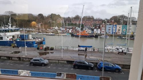 a group of cars parked at a marina with boats at The Ocean Guest House in Weymouth