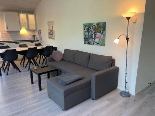 a living room with a couch and a table at Emda Country living close to Legoland in Billund