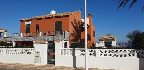 a house with a white fence in front of it at Vacansis Habitaciones Privada en una Villa a un paso del Mar en Cullera in Cullera