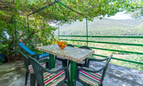 a table and chairs on a porch with a view at Apartment Feel the nature in Slime