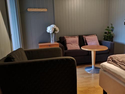 a living room with a couch and a table at Homestay Storesund in Storasund