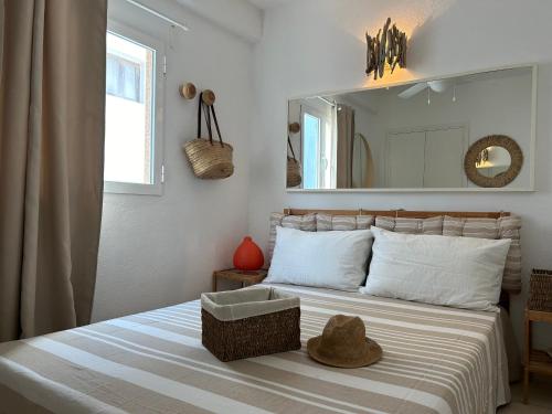 a bedroom with a bed with a hat on it at Es Pujols Vista Mare in Es Pujols