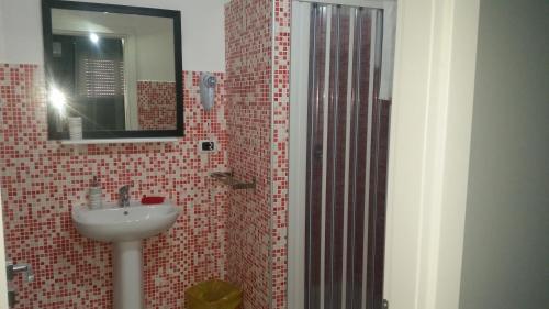 a bathroom with a sink and a mirror at B&B Colors in Sellia Marina