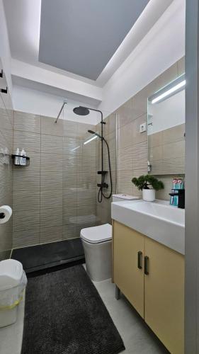 a bathroom with a sink and a toilet and a mirror at Papagayo Beach Apartments in Arona