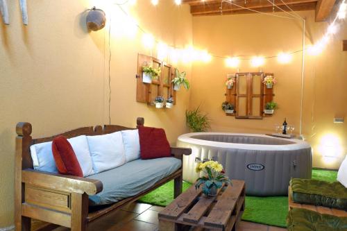a living room with a tub and a couch at Casas Rurales Florentino in Robledillo