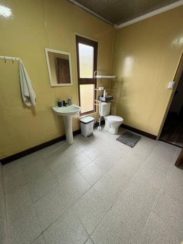 a bathroom with two toilets and a sink at La Finca - Santa Cruz - Chile in Santa Cruz