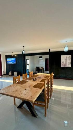 a large wooden table in a room with chairs at La Finca - Santa Cruz - Chile in Santa Cruz