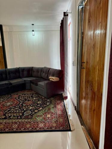 a living room with a couch and a rug at La Finca - Santa Cruz - Chile in Santa Cruz