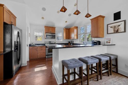 a kitchen with a counter with stools and a refrigerator at Wild Horse Run in New Buffalo