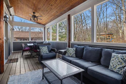 a screened in porch with a couch and a table at Wild Horse Run in New Buffalo