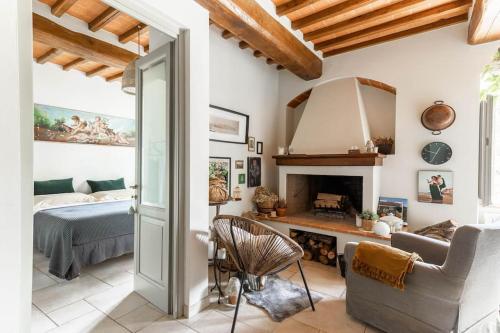 a living room with a bed and a fireplace at La Casa di Nada Home in Tavarnelle in Val di Pesa
