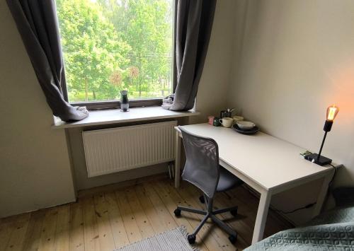 a room with a desk and a window with a chair at VEPA in Vepriai