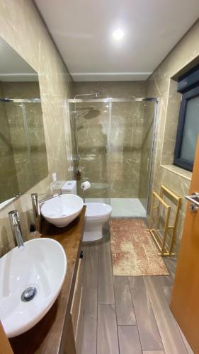 a bathroom with two sinks and a shower at Casa do Miradouro Mondim de Basto in Mondim de Basto