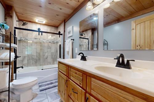 a bathroom with a sink and a toilet and a tub at Morganton Escape in Morganton